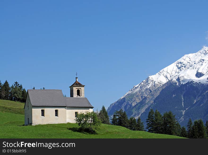 Lovely landscape in the swiss alps featuring an old church. Lovely landscape in the swiss alps featuring an old church