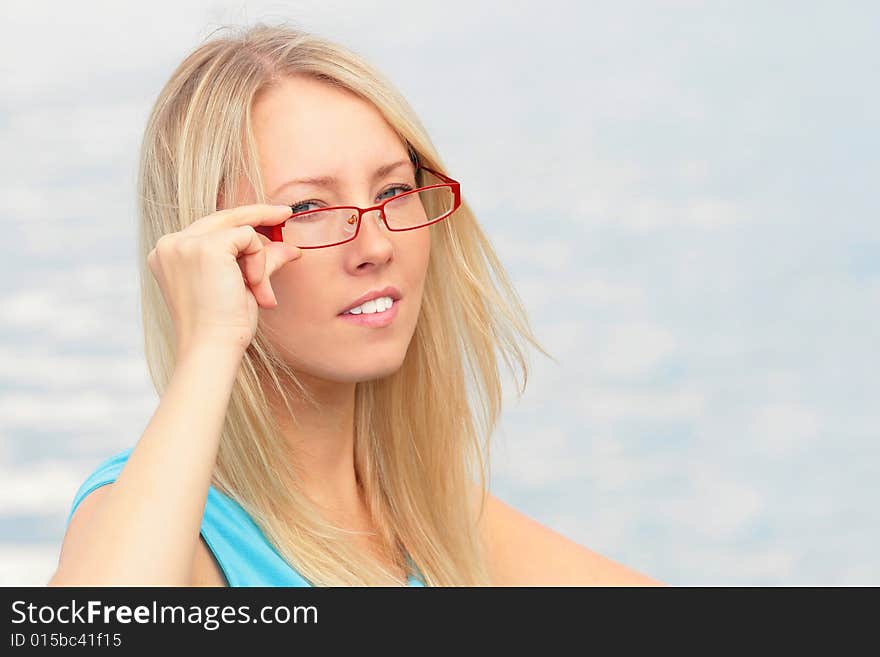 Photo of the charming girl chooses the model of collets to glasses. Photo of the charming girl chooses the model of collets to glasses.