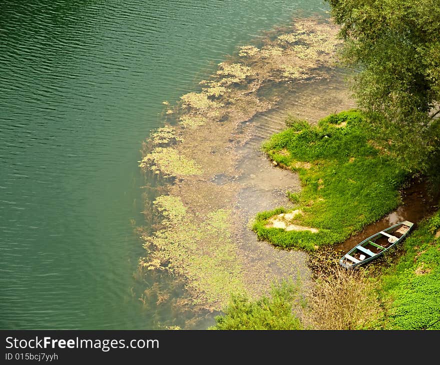 Old boat floating on a green river. Old boat floating on a green river