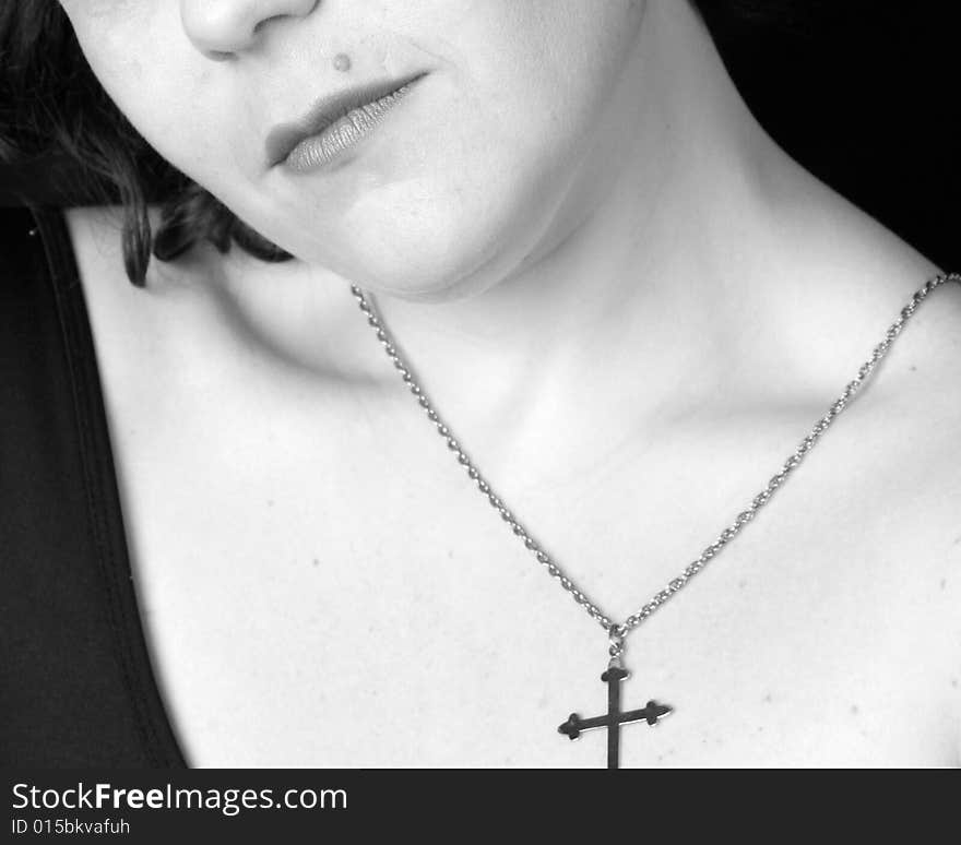 WonmanÂ´s body part with religious symbol crucifix. WonmanÂ´s body part with religious symbol crucifix