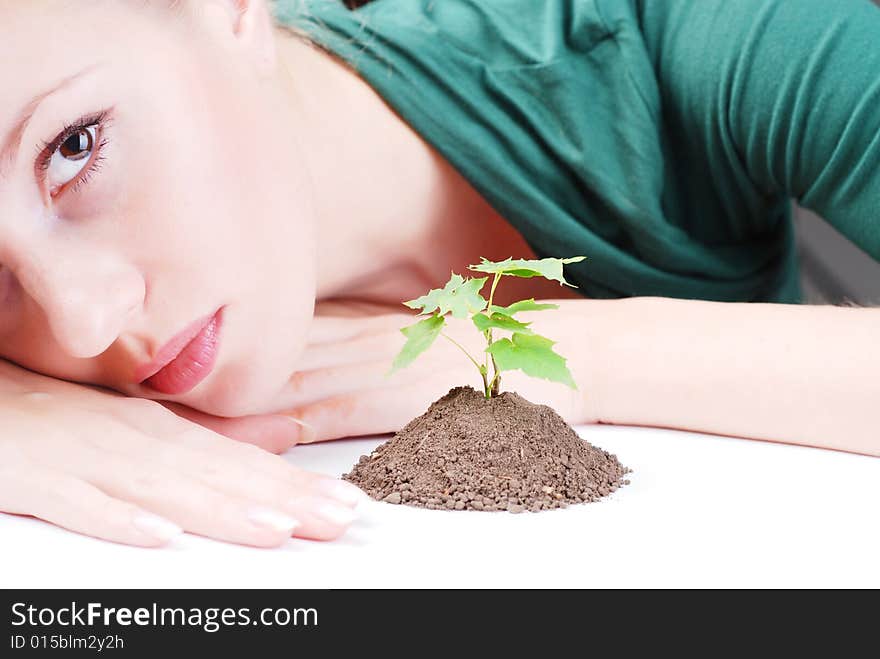 Beautiful young woman with green sprout of tree. Beautiful young woman with green sprout of tree