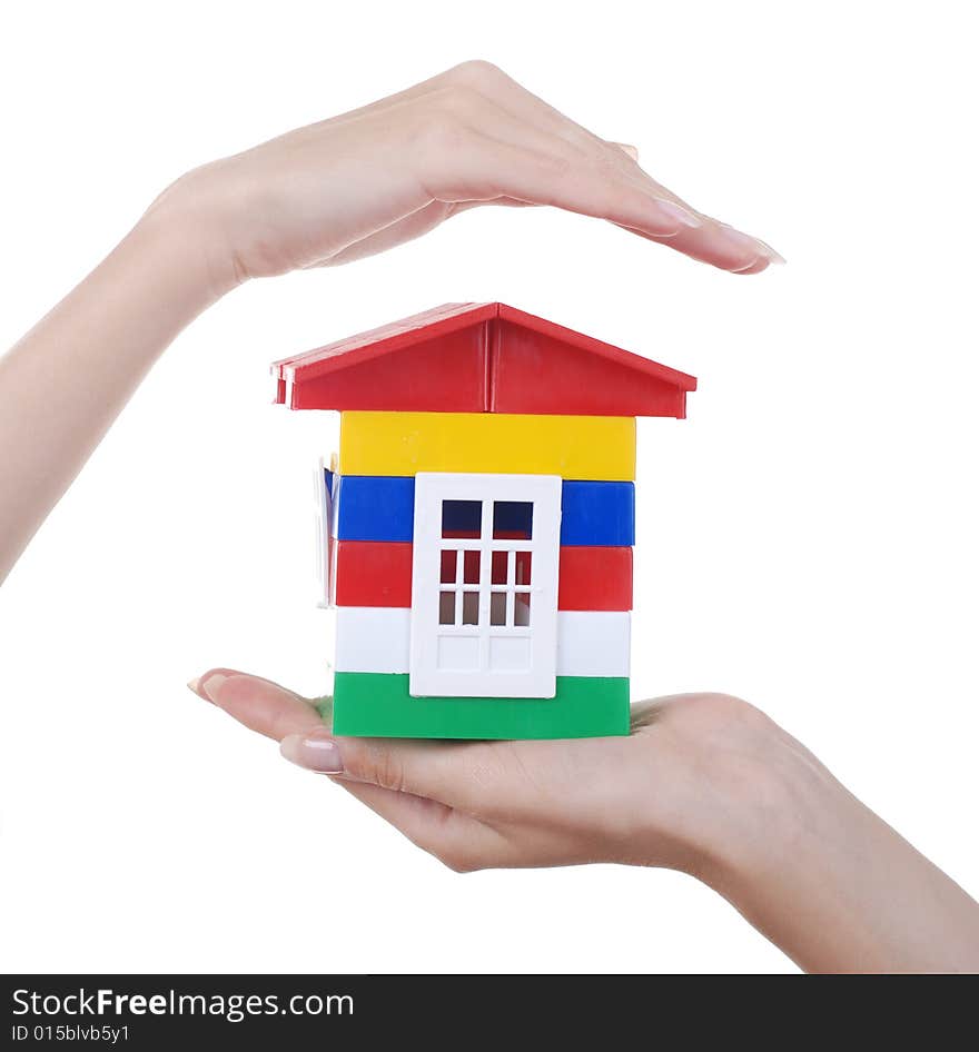 Toy colour plastic house with red roof in palms of young woman. Toy colour plastic house with red roof in palms of young woman