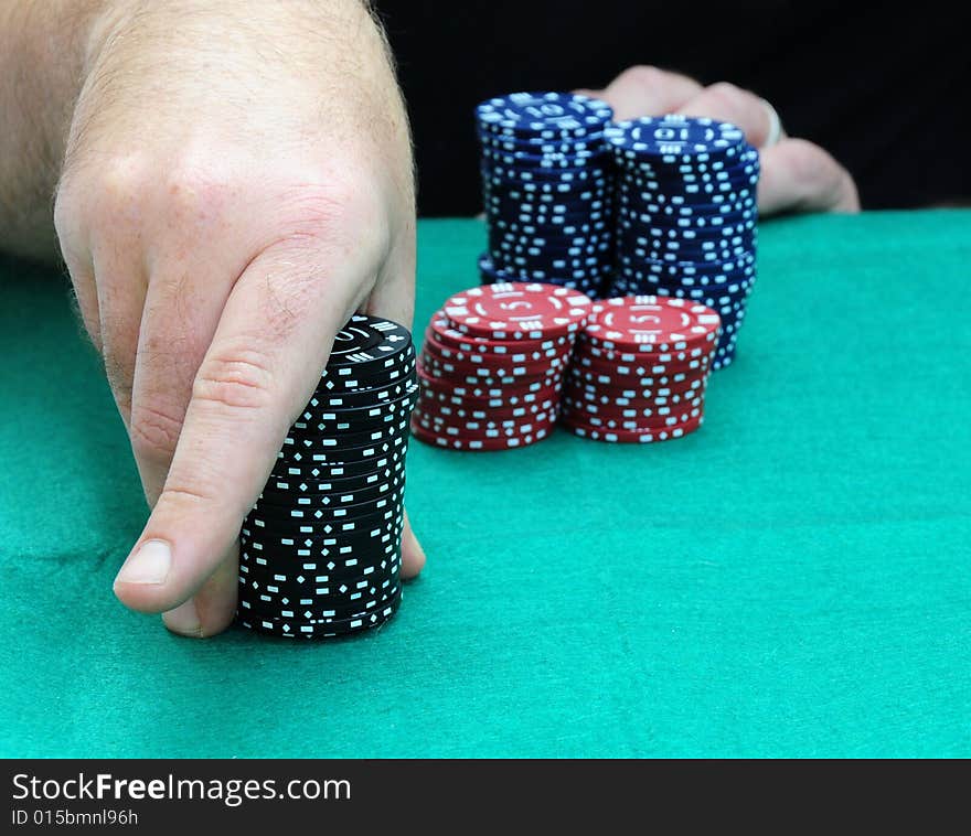 Shot of a player playing a game of poker. Shot of a player playing a game of poker