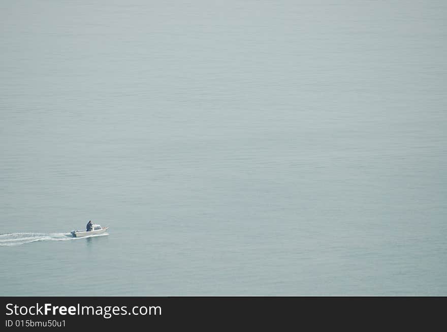 Solitary Boat Crossing Water