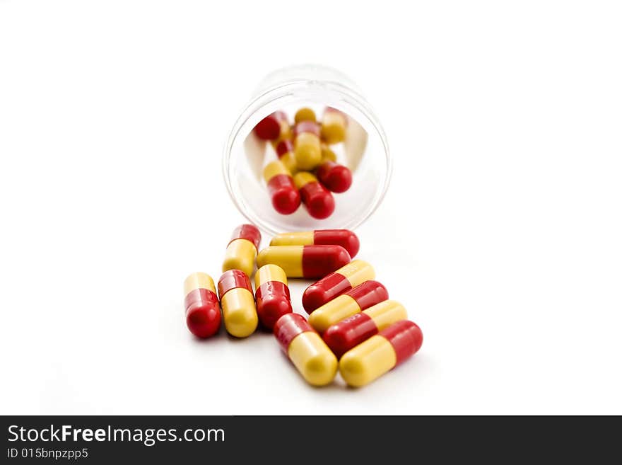 A bottle of pills on a white background