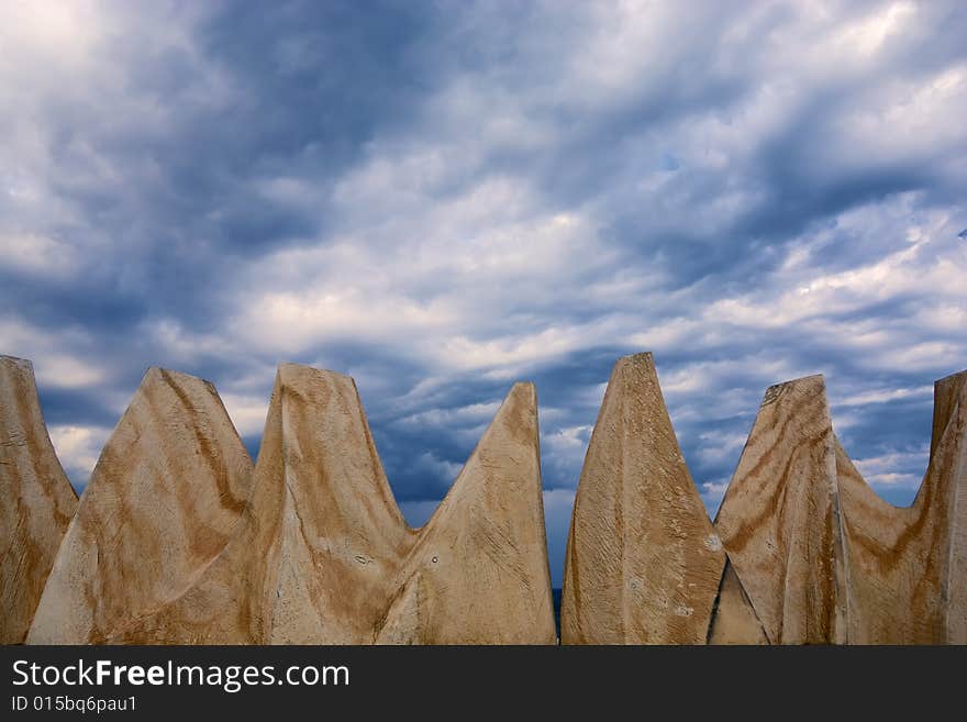 Dark stormy clouds and brown rocks. Dark stormy clouds and brown rocks