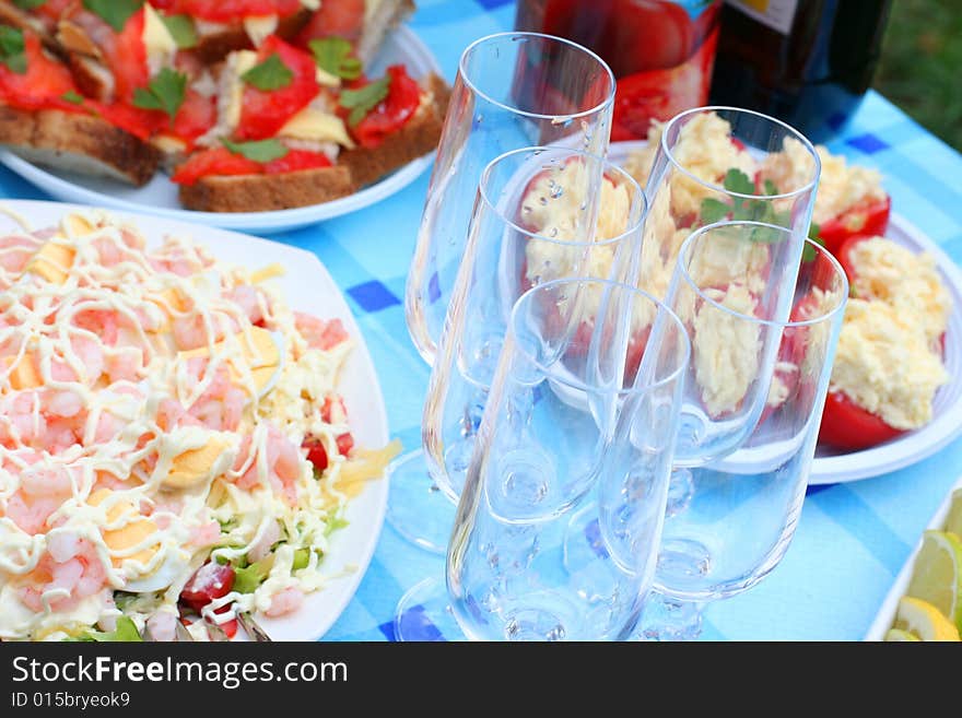 Blue table with salad and snacks. Blue table with salad and snacks