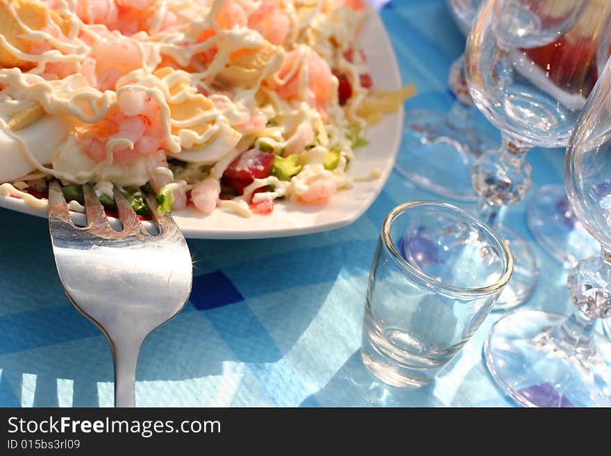 Blue table with salad and snacks