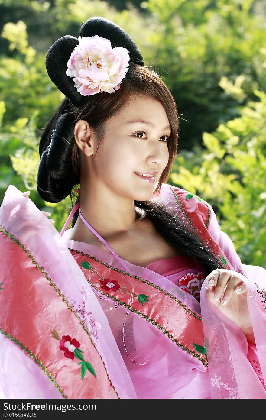 A girl in Chinese ancient dress. She wave pleasant posture. A girl in Chinese ancient dress. She wave pleasant posture..