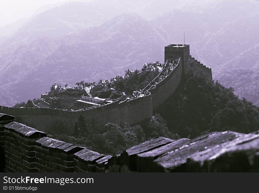 The part of Great Wall in China, wriggling among the mountains. The grand building show the agglomeration of ancient Chinese.