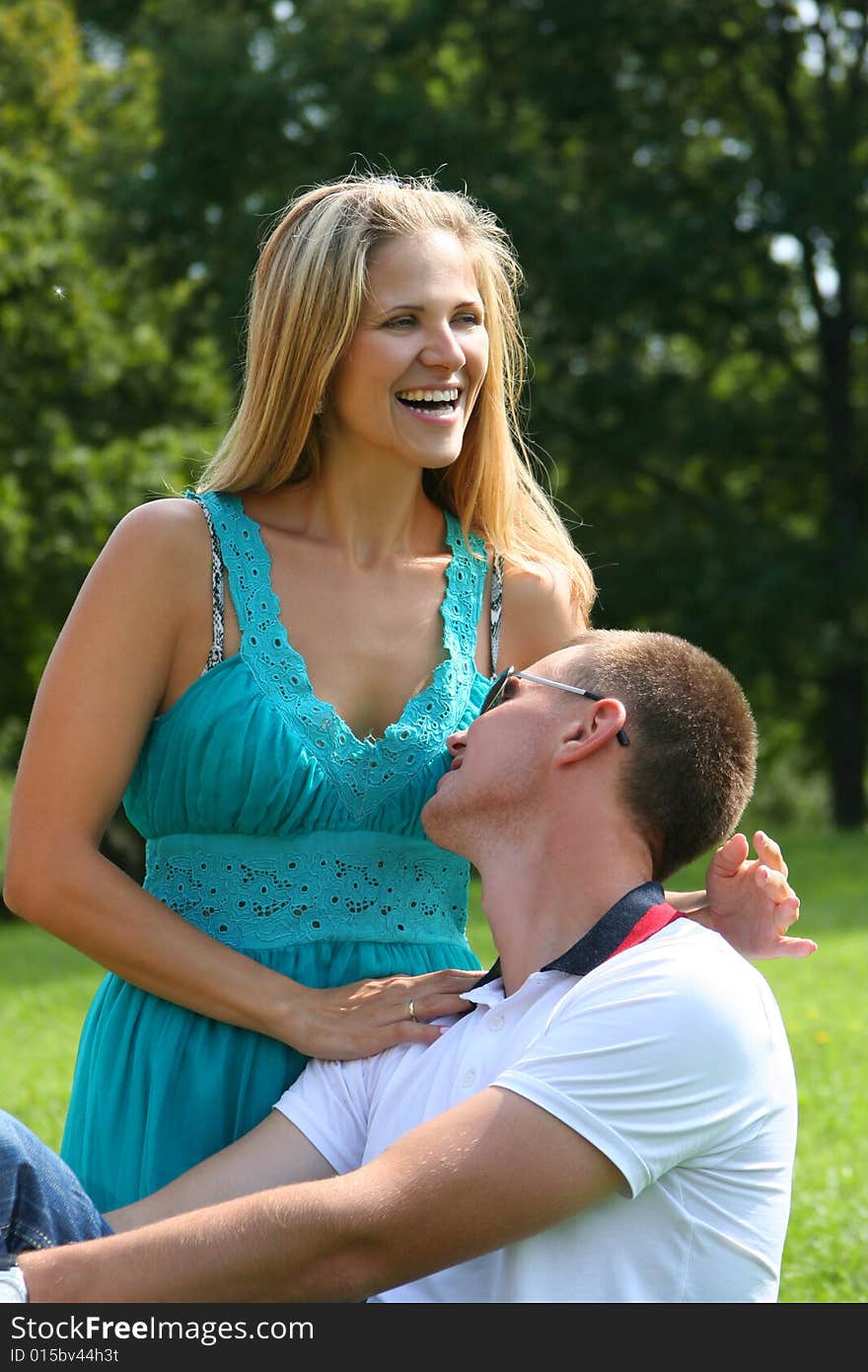 Happy young couple relaxing in park. Happy young couple relaxing in park