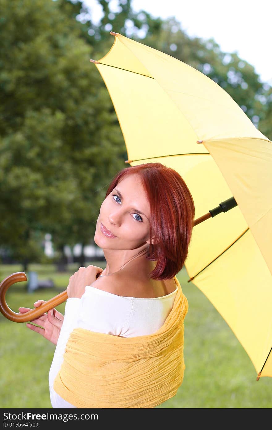 Beautiful young girl under yellow umbrella. Beautiful young girl under yellow umbrella