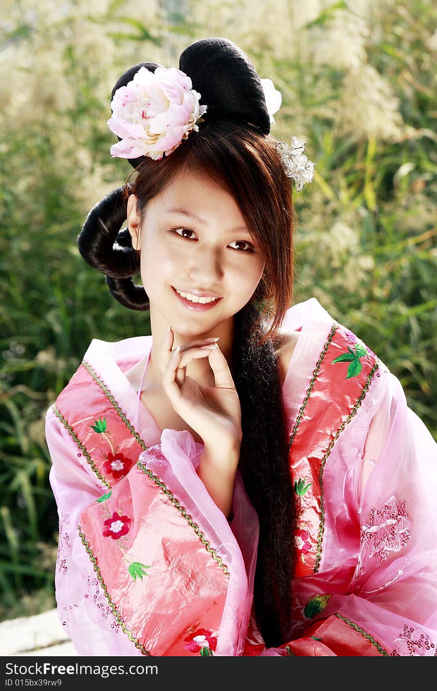 A girl in Chinese ancient dress. 
She wave pleasant posture. A girl in Chinese ancient dress. 
She wave pleasant posture..