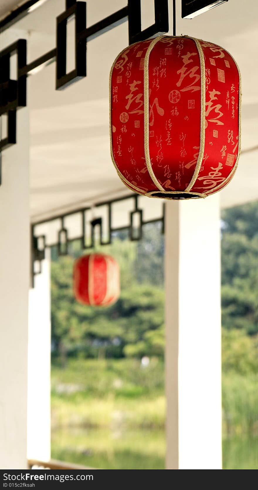 Red lantern hung in the Chinese teahouse. 

Chinese on the lantern is the ancient poesy of China, the main idea is the praise of tea culture.