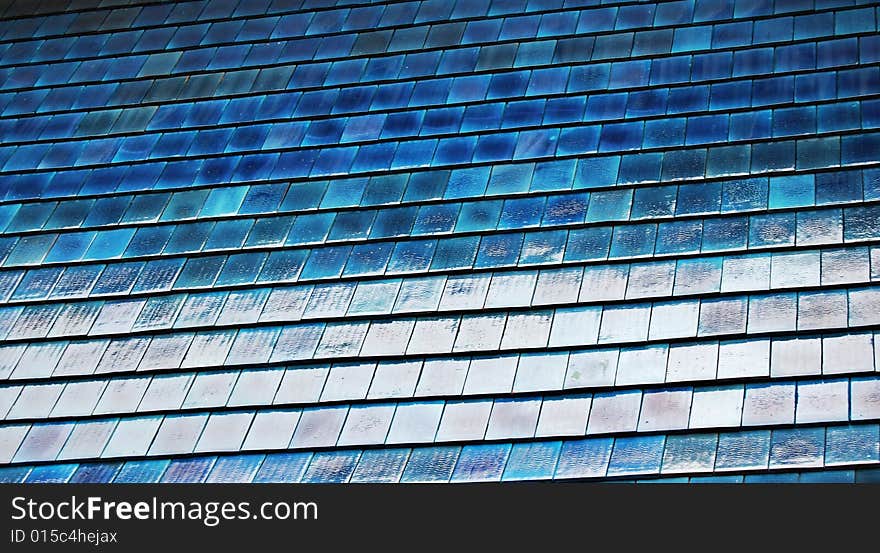 Large portion of a blue roof with shingles useful for texture or background