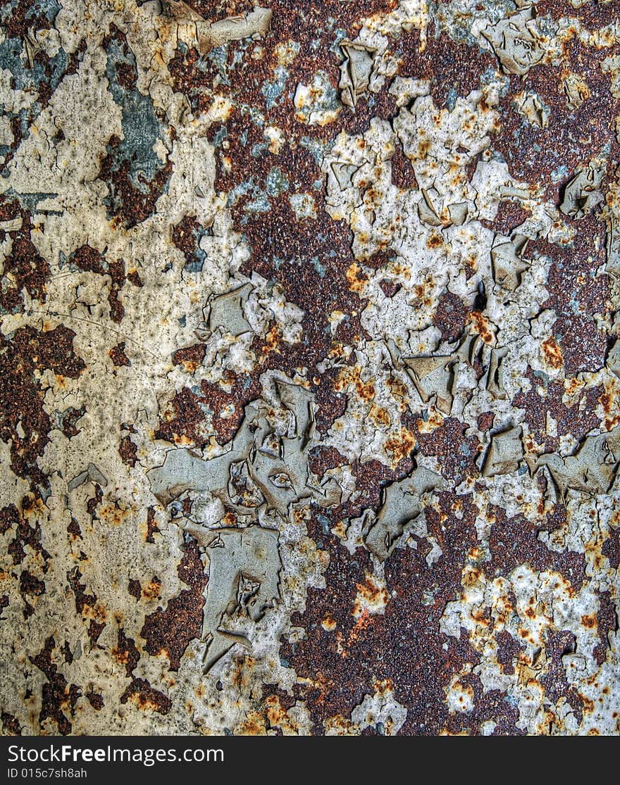 Details of rusting metal with peeling paint.