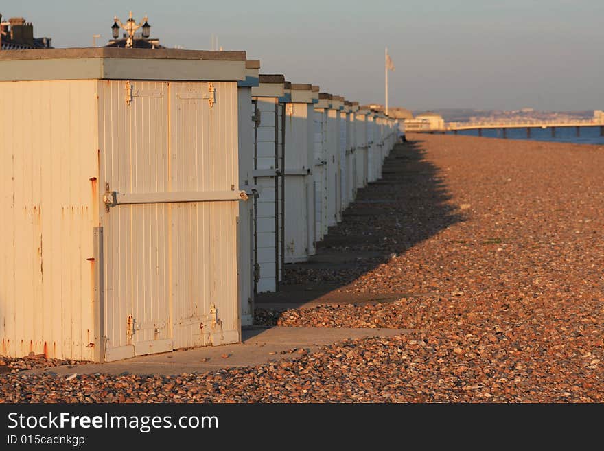 Sunset beach huts and pier