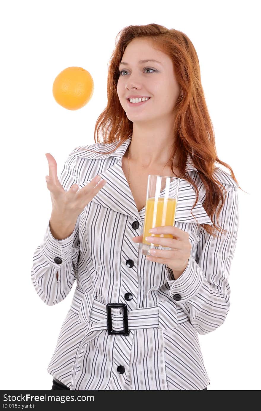 Portrait of a happy young pretty woman drink juice and   toss up an orange