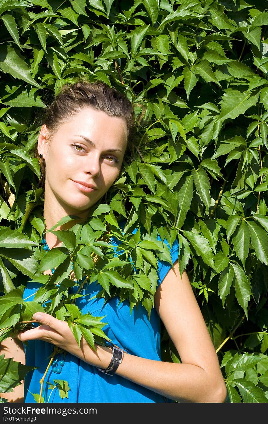 Smiling woman with green vine. Smiling woman with green vine