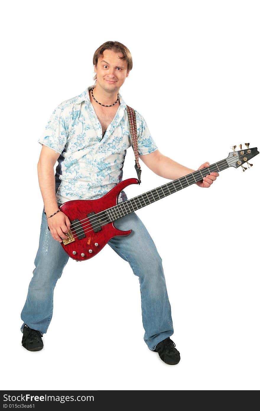 Young man with guitar dancing on white