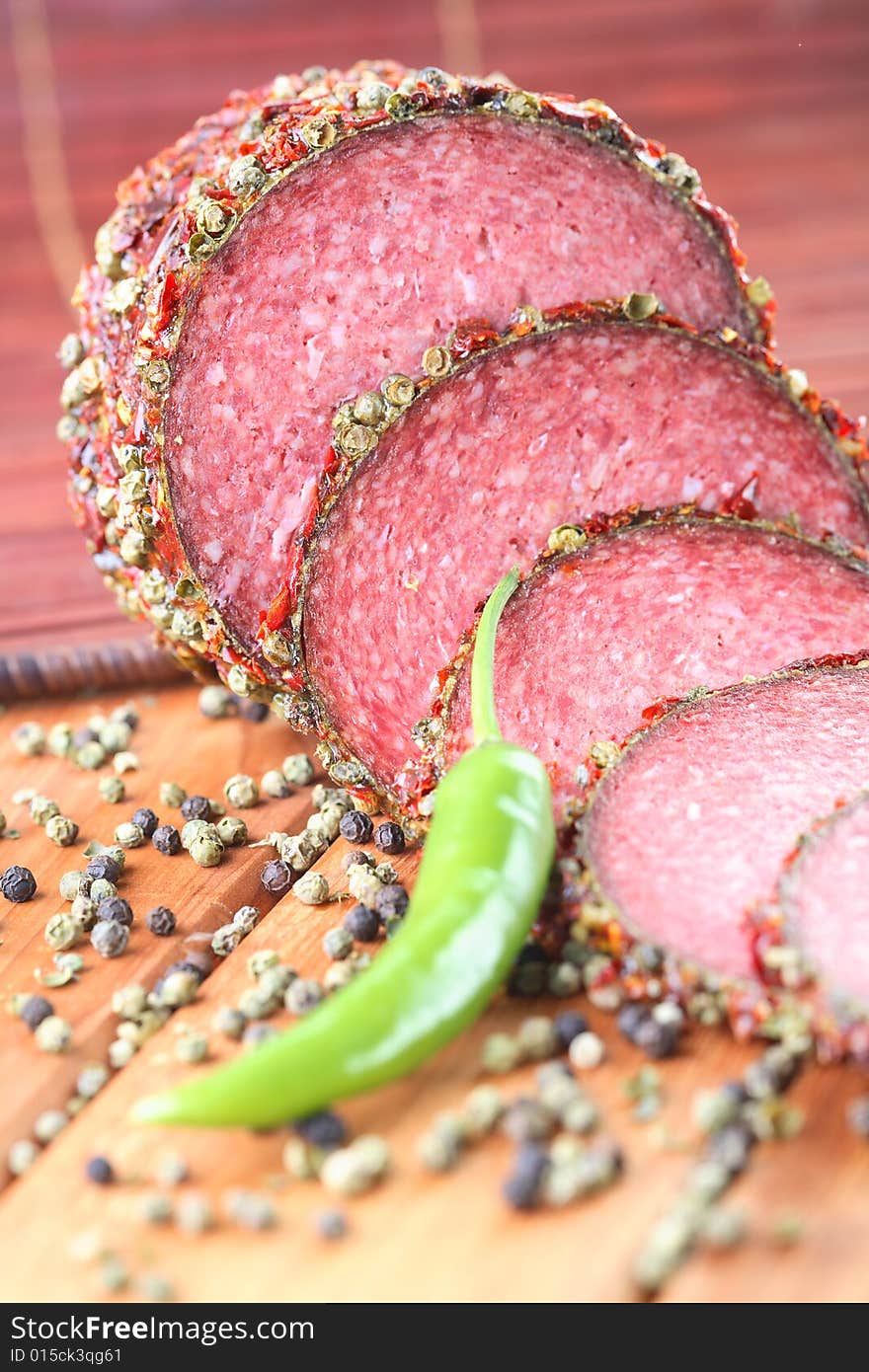 Salami and green pepper on the table