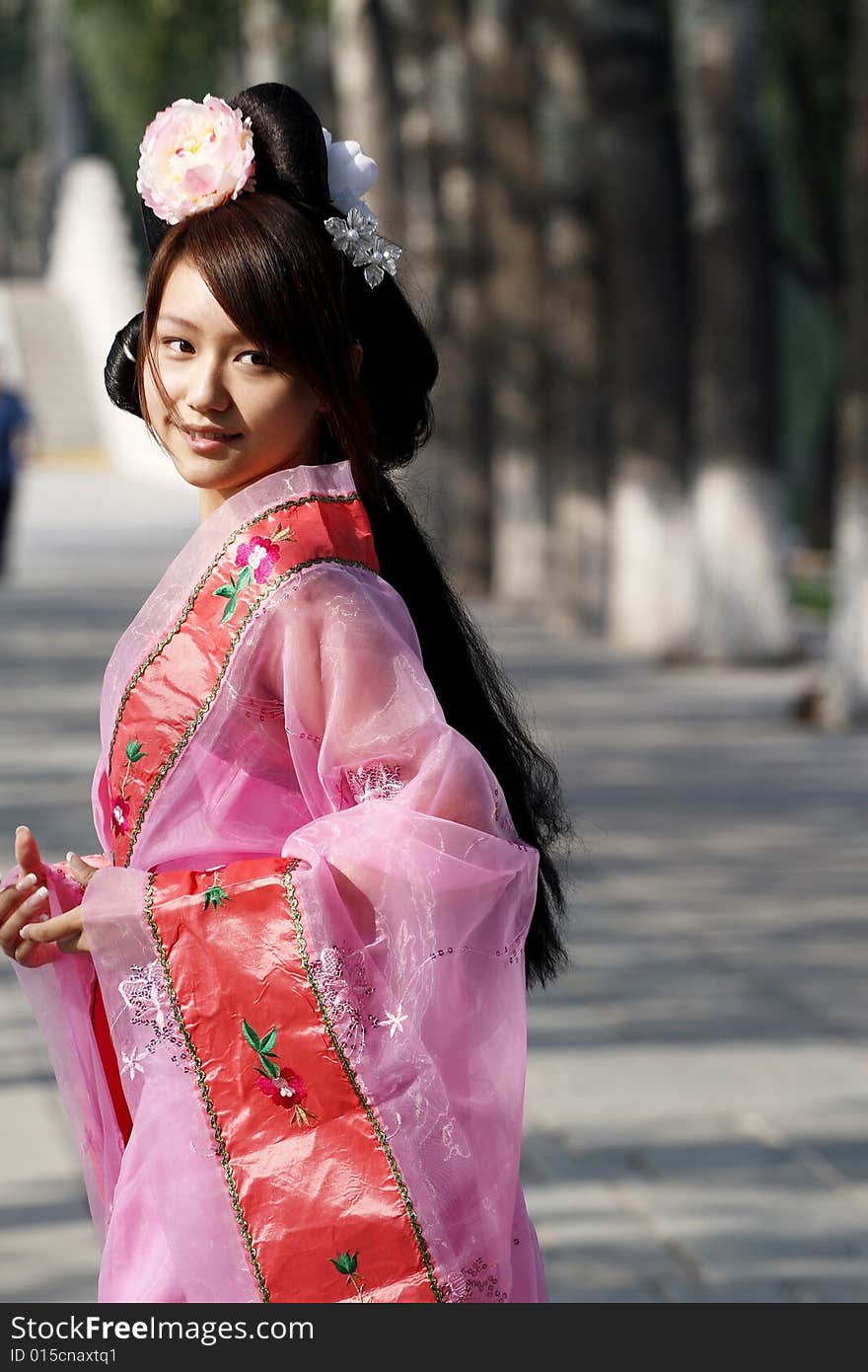 A girl in Chinese ancient dress. She wave pleasant posture. A girl in Chinese ancient dress. She wave pleasant posture..