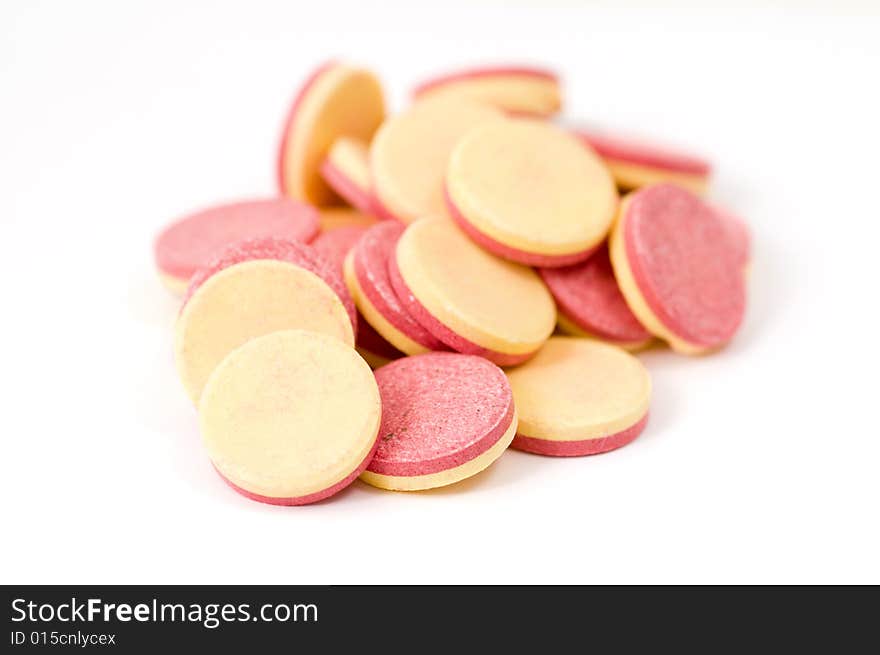 Close-up of vitamin tablets isolated on white background, shallow focus