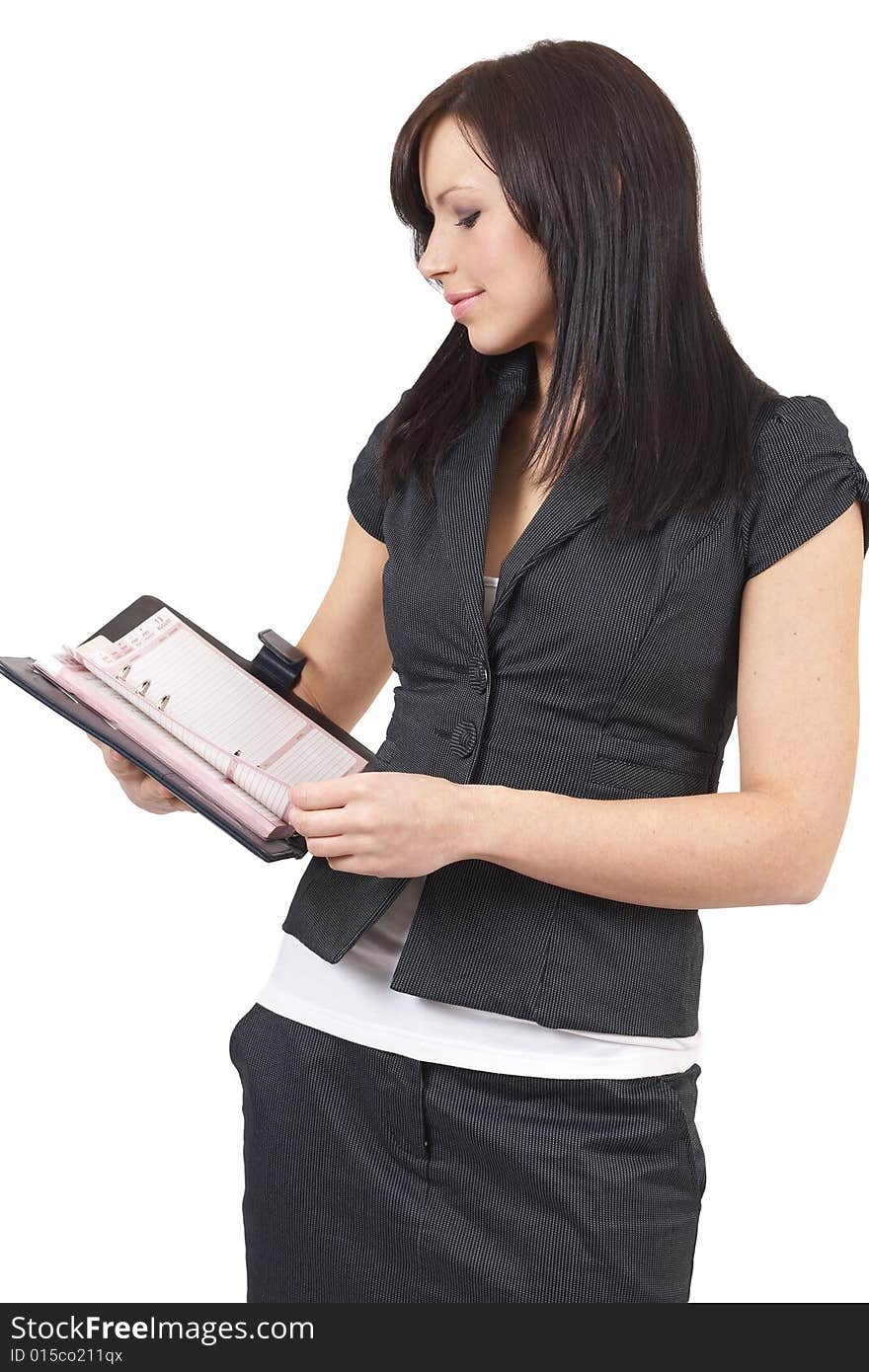 Beautiful young brunette businesswoman wearing a black jacket holding the diary. Isolated on white background with copy space. Beautiful young brunette businesswoman wearing a black jacket holding the diary. Isolated on white background with copy space