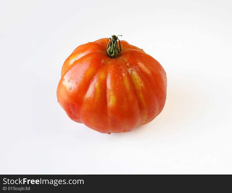 Fresh 'coeur de boeuf' (beefsteak) tomato on white background. Fresh 'coeur de boeuf' (beefsteak) tomato on white background