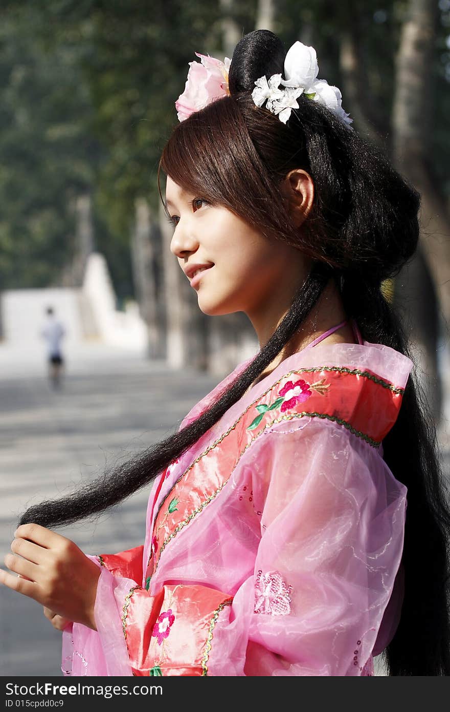 A girl in Chinese ancient dress. She wave pleasant posture. A girl in Chinese ancient dress. She wave pleasant posture