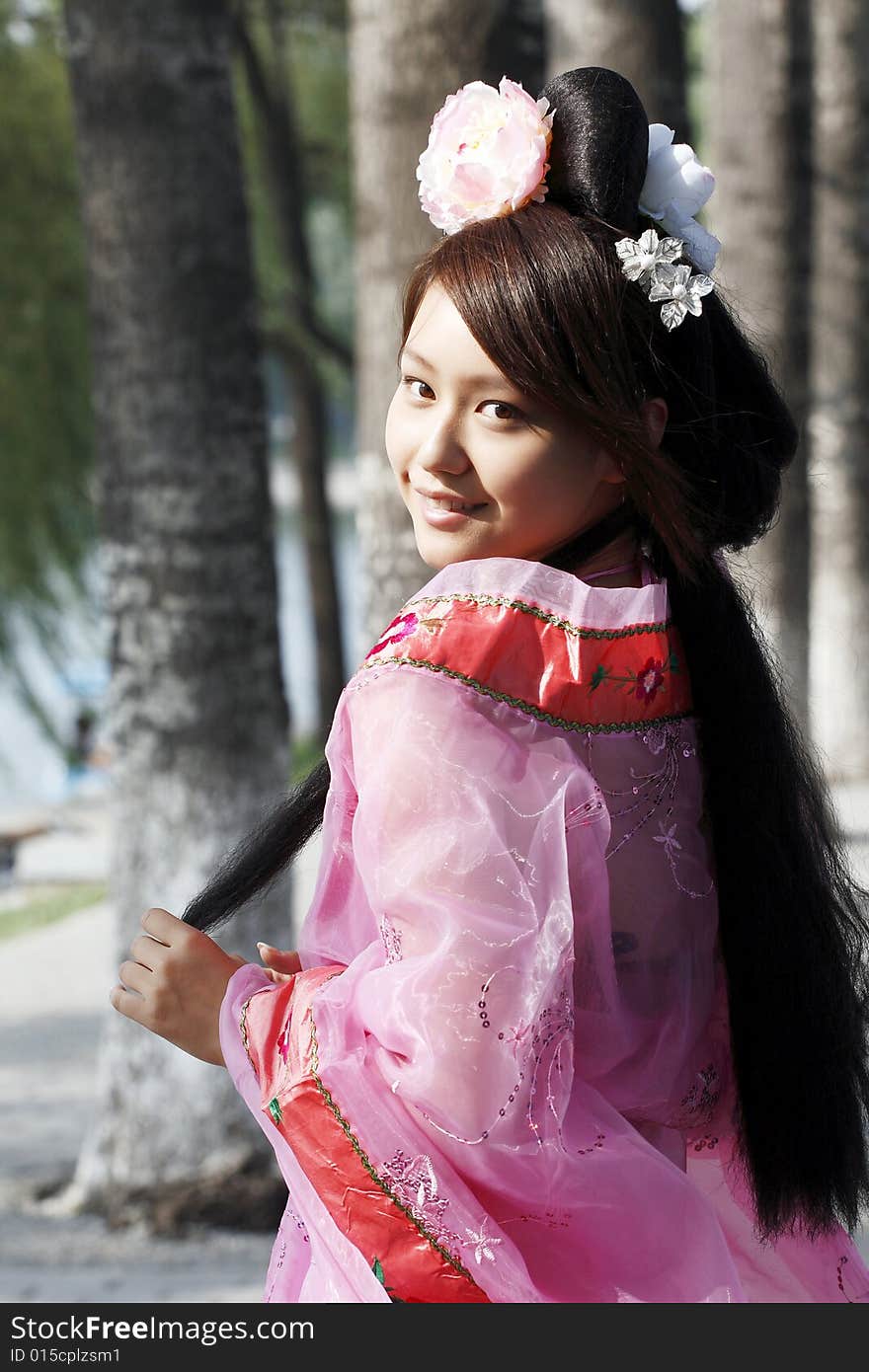 A girl in Chinese ancient dress. She wave pleasant posture. A girl in Chinese ancient dress. She wave pleasant posture..