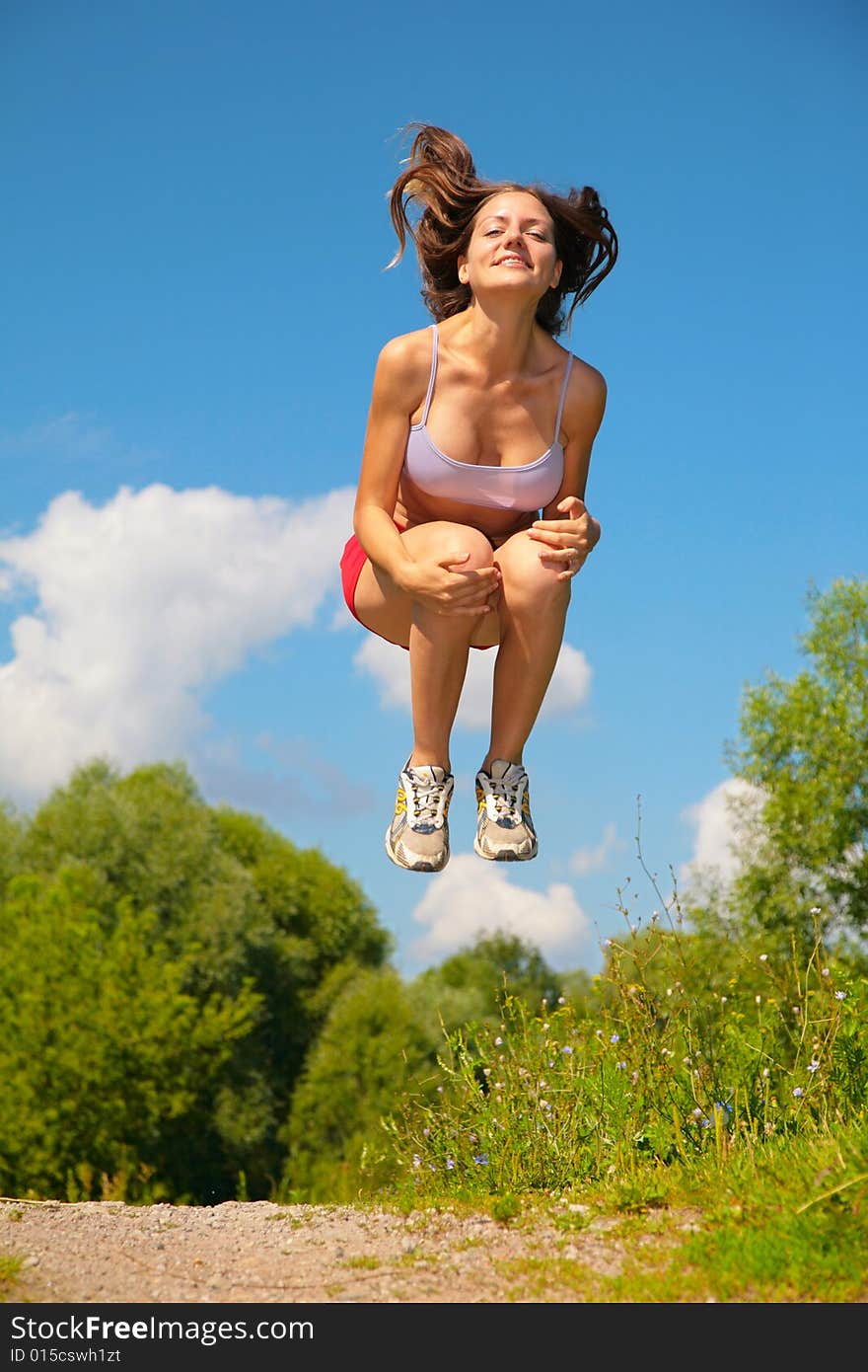 Young woman jumping, summer park