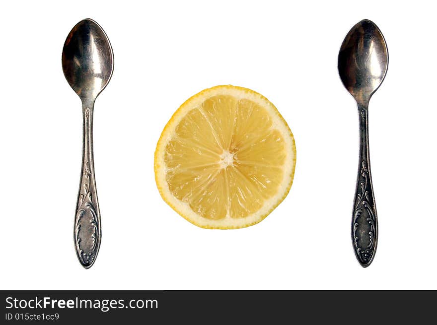 Two spoons and lemon slice on white background