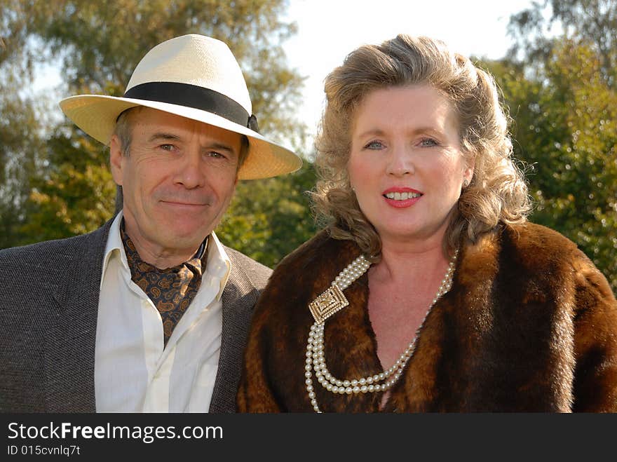 Mature couple in  fifties vintage costume at Goodwood Revival event, UK. Mature couple in  fifties vintage costume at Goodwood Revival event, UK