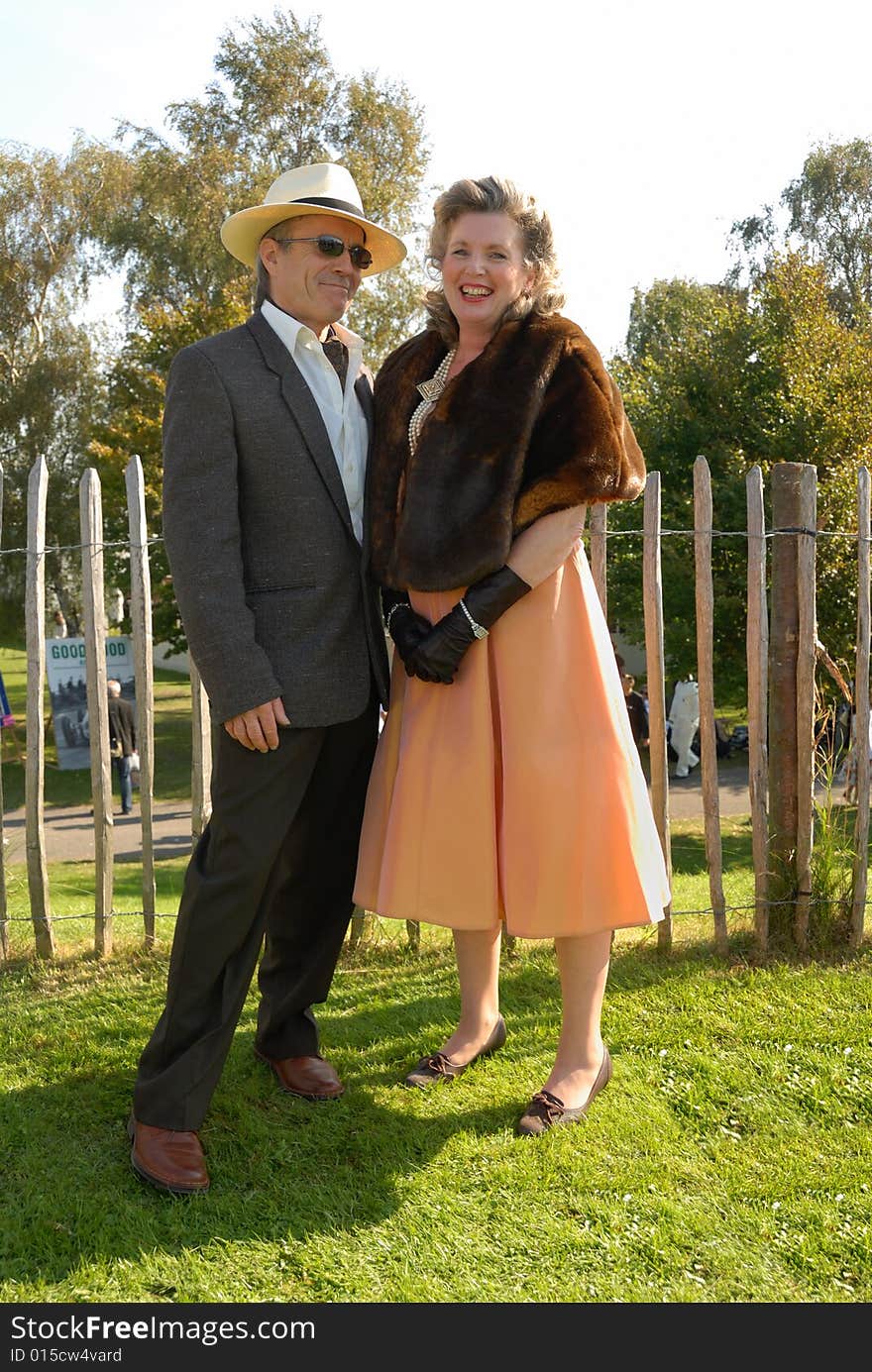 Mature couple in  fifties vintage costume at Goodwood Revival event, UK. Mature couple in  fifties vintage costume at Goodwood Revival event, UK