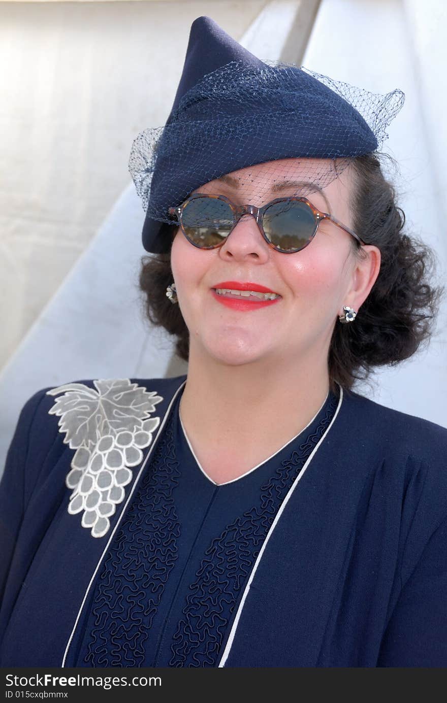 Retro girl in sunglasses at Goodwood Revival event, UK