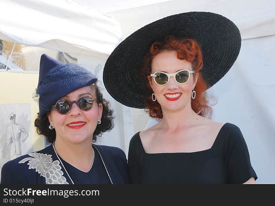 Glamorous girls in fifties vintage costume at Goodwood Revival event, UK. Glamorous girls in fifties vintage costume at Goodwood Revival event, UK