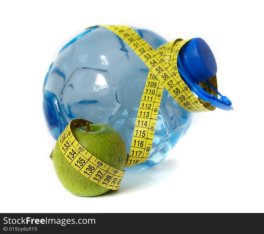 Plastic water bottle and green apple isolated