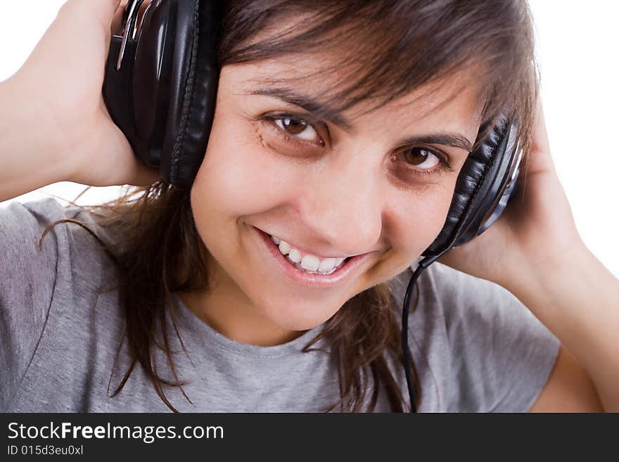 Young woman listening music with headphones isolated on white background