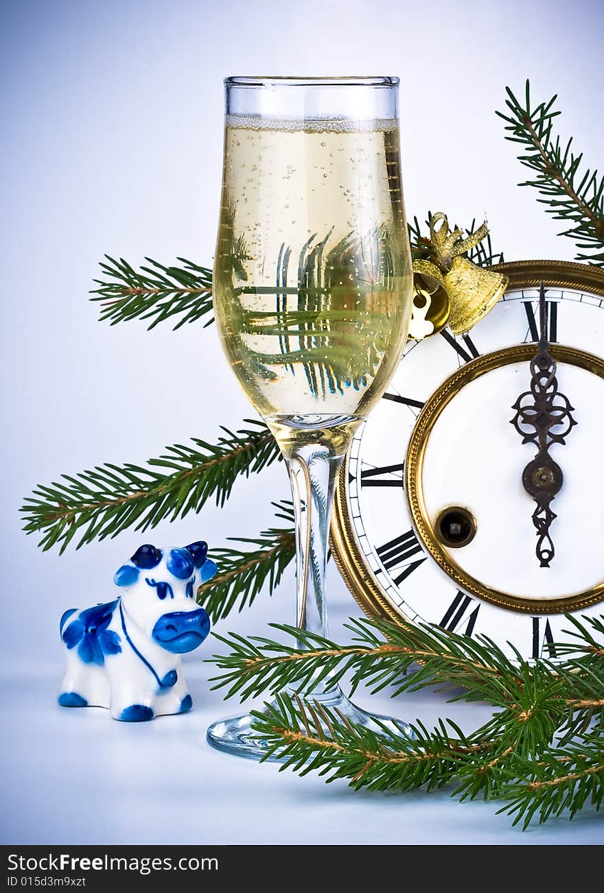 New Year's decoration with an antique clock and a firtree branch