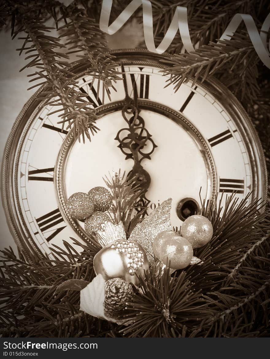 New Year's decoration with an antique clock and a firtree branch