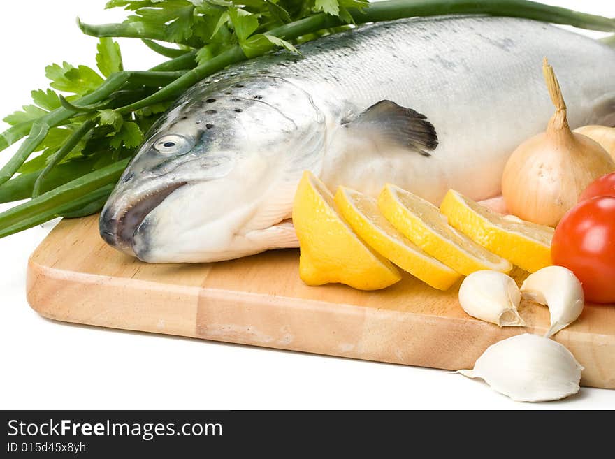 Fresh raw salmon with vegetables on a white background. Fresh raw salmon with vegetables on a white background