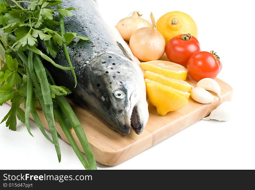 Fresh raw salmon with vegetables on a white background. Fresh raw salmon with vegetables on a white background