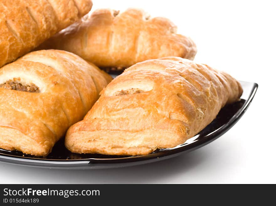 Fresh rolls on a plate on a white background