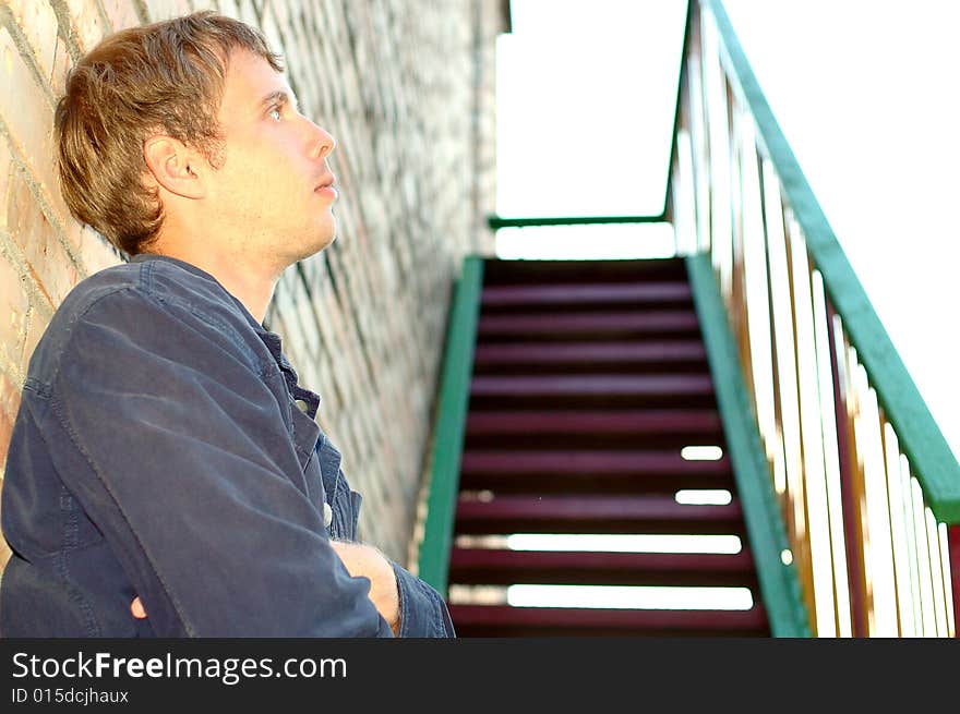 Young stylish man stand near stairs.