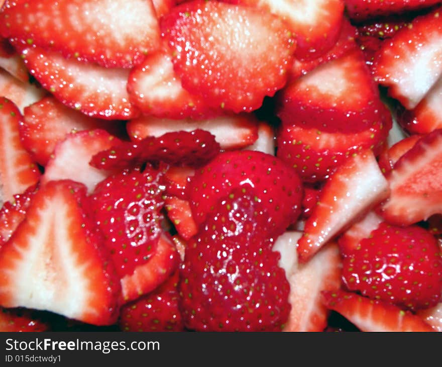 A bowl full of sliced strawberries