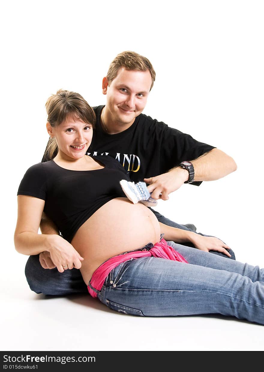 Young man and his pregnant wife isolated against white background