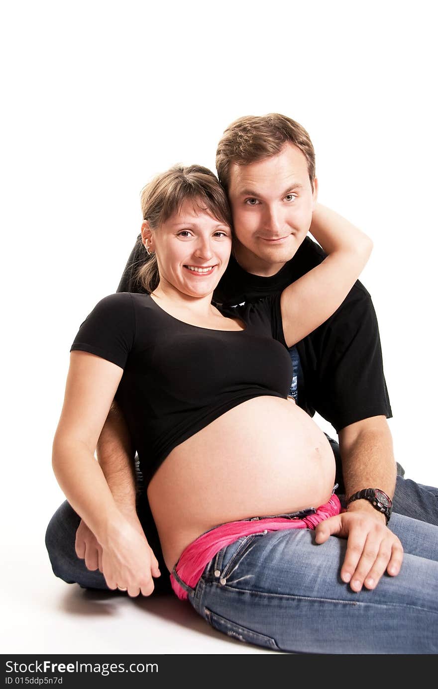 Happy pregnant woman and her husband isolated against white background