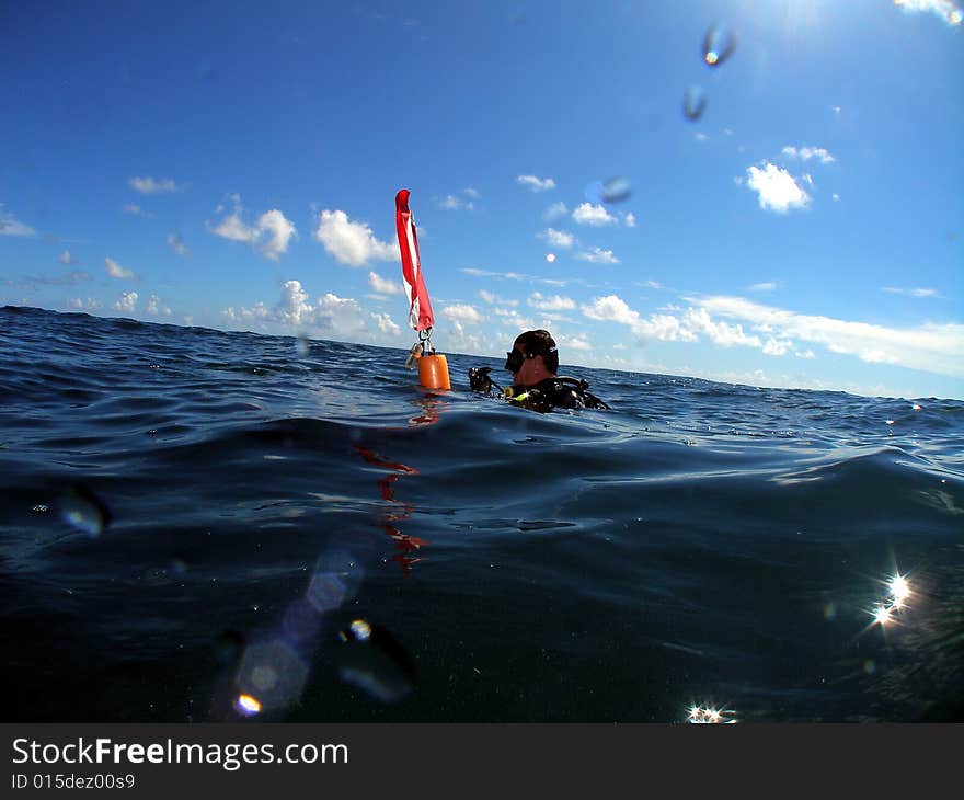 Diver at the surface after a dive on Turtle Ledge reef in Pompano Beach, Florida. Waiting to be picked up. Diver at the surface after a dive on Turtle Ledge reef in Pompano Beach, Florida. Waiting to be picked up.