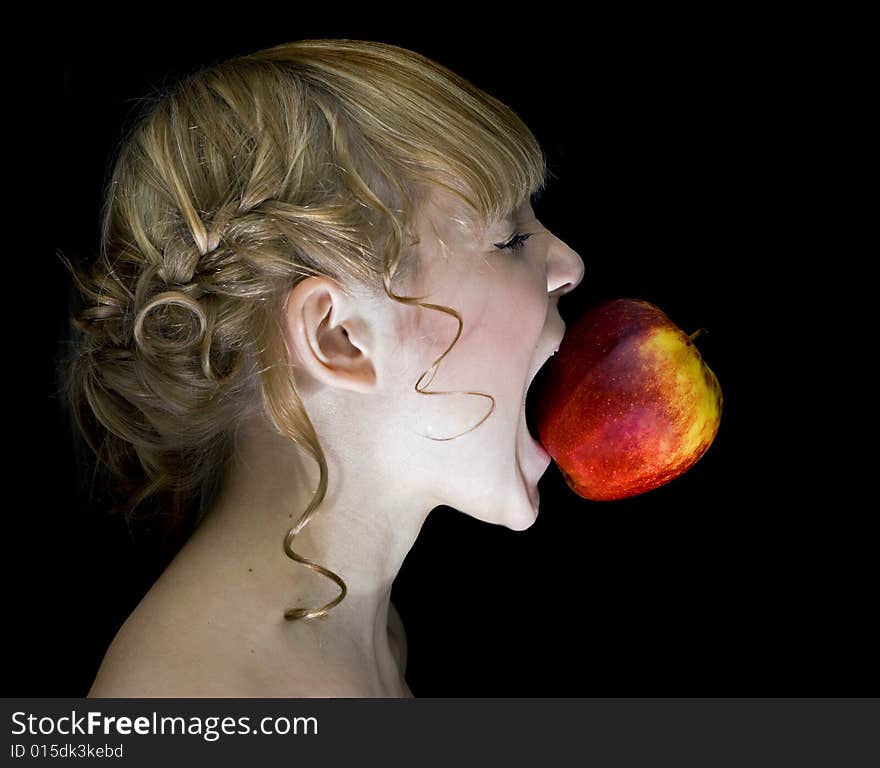 Girl,eating apple over the black background. Girl,eating apple over the black background